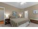 Spacious bedroom with neutral walls, a comfortable bed, and a glimpse into the attached, bright bathroom at 92 Summer Dawn, Pittsboro, NC 27312