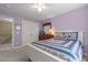 Comfortable bedroom with white bed, ceiling fan, light purple walls, and closet at 92 Summer Dawn, Pittsboro, NC 27312