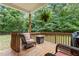 Relaxing covered deck with comfortable seating and wooded views for outdoor enjoyment at 92 Summer Dawn, Pittsboro, NC 27312