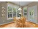 Sun-filled dining area featuring wood floors, a round table, and natural light at 92 Summer Dawn, Pittsboro, NC 27312