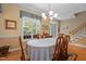 Bright dining room with a large window, hardwood floors, and classic wooden furniture at 92 Summer Dawn, Pittsboro, NC 27312