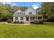 Charming two-story home with a inviting front porch, lush landscaping, and beautiful lawn at 92 Summer Dawn, Pittsboro, NC 27312