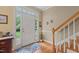 Bright foyer with hardwood floors, staircase, and charming decor, creating a welcoming atmosphere at 92 Summer Dawn, Pittsboro, NC 27312