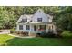 Charming two-story home with a large front porch and manicured lawn at 92 Summer Dawn, Pittsboro, NC 27312