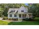 Attractive two-story home featuring mature landscaping and front porch at 92 Summer Dawn, Pittsboro, NC 27312