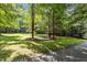 Expansive front yard of home featuring mature trees and lush green grass at 92 Summer Dawn, Pittsboro, NC 27312