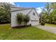 Home showing the garage and driveway situated on a spacious, landscaped lot at 92 Summer Dawn, Pittsboro, NC 27312