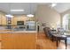 Open kitchen with stainless steel appliances, wood cabinets, connecting to a well-lit living room at 92 Summer Dawn, Pittsboro, NC 27312