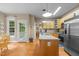 Bright kitchen featuring wood floors, stainless steel appliances, custom cabinetry, and an island at 92 Summer Dawn, Pittsboro, NC 27312