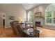 Bright living room with fireplace, comfortable seating, and lots of natural light from large windows at 92 Summer Dawn, Pittsboro, NC 27312