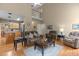 Open living room connected to the kitchen, featuring hardwood floors, comfortable seating, and high ceilings at 92 Summer Dawn, Pittsboro, NC 27312