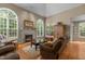 Inviting living room featuring a fireplace, plenty of seating, and large windows for natural light at 92 Summer Dawn, Pittsboro, NC 27312
