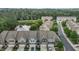 Aerial view of neighborhood featuring a pond and well-maintained townhomes surrounded by lush greenery at 9302 Nellman Ln, Raleigh, NC 27617
