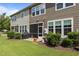A covered BBQ on a patio with screened-in entrance and grass and landscaping at 9302 Nellman Ln, Raleigh, NC 27617
