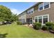 A well-manicured backyard with a screened-in patio, BBQ, and mature trees at 9302 Nellman Ln, Raleigh, NC 27617