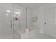Bright, clean bathroom with glass-enclosed shower, soaking tub, and modern fixtures at 9302 Nellman Ln, Raleigh, NC 27617
