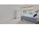 Well-lit bedroom featuring neutral walls, carpet, striped bedspread and window with privacy blinds at 9302 Nellman Ln, Raleigh, NC 27617