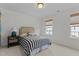Serene bedroom with neutral walls, a comfortable bed, and bright natural light from multiple windows at 9302 Nellman Ln, Raleigh, NC 27617