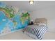Decorated bedroom featuring a statement wall map, a striped bedspread, and complementing bedside table at 9302 Nellman Ln, Raleigh, NC 27617