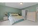 Comfortable bedroom featuring soft green walls, carpet and a plush bed with decorative pillows and a matching dresser at 9302 Nellman Ln, Raleigh, NC 27617