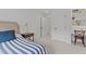 Serene bedroom featuring neutral decor, a striped bedspread, and ample closet space for easy organization at 9302 Nellman Ln, Raleigh, NC 27617