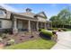 Community clubhouse with stone columns, inviting entrance, and manicured landscaping at 9302 Nellman Ln, Raleigh, NC 27617