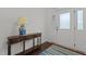 Bright entryway features wood floors, front door with sidelights, and a table with drawers topped with a decorative lamp at 9302 Nellman Ln, Raleigh, NC 27617