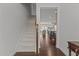 Entryway featuring a carpeted staircase and hardwood floors looking through to the kitchen and living room at 9302 Nellman Ln, Raleigh, NC 27617