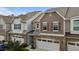 Exterior of a two-story townhome showcasing stone accents, garage, and architectural detail at 9302 Nellman Ln, Raleigh, NC 27617