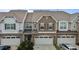A neighborhood of two-story townhomes with two-car garages and landscaping at 9302 Nellman Ln, Raleigh, NC 27617