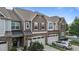 A two-story townhome with stone accents, a two-car garage, and manicured landscaping at 9302 Nellman Ln, Raleigh, NC 27617