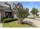 Charming two-story townhome featuring stone accents, a front-entry garage, and lush landscaping at 9302 Nellman Ln, Raleigh, NC 27617