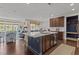 Open concept kitchen, dining, and living room featuring an island with seating and stainless steel appliances at 9302 Nellman Ln, Raleigh, NC 27617