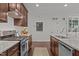 Modern kitchen features stainless steel appliances, granite countertops, and sleek wooden cabinets at 9302 Nellman Ln, Raleigh, NC 27617