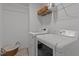 Functional laundry room with a side-by-side washer and dryer, and shelving for storage at 9302 Nellman Ln, Raleigh, NC 27617