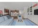 Open-concept living room featuring a built-in bookcase and seamless flow into a kitchen with a center island at 9302 Nellman Ln, Raleigh, NC 27617