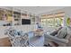 Cozy living room with custom built-ins, plush seating, and natural light from the windows at 9302 Nellman Ln, Raleigh, NC 27617
