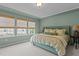 Inviting main bedroom with a tray ceiling, bamboo shades, and light-green colored walls at 9302 Nellman Ln, Raleigh, NC 27617