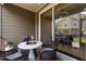 Relaxing screened patio area perfect for entertaining with wicker furniture, and a view of the yard at 9302 Nellman Ln, Raleigh, NC 27617