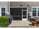 Patio with a BBQ, a screened door, and landscaping on the patio at 9302 Nellman Ln, Raleigh, NC 27617