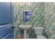 Charming powder room features custom wallpaper, pedestal sink, and designer fixtures at 9302 Nellman Ln, Raleigh, NC 27617