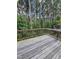 View of a rustic wooden back deck overlooking a wooded area filled with trees and greenery at 1005 Lathrop Ln, Apex, NC 27523