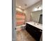 Functional bathroom featuring a double sink vanity, neutral color scheme and shower with patterned curtain at 1005 Lathrop Ln, Apex, NC 27523