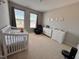 Comfortable Bedroom with crib, dresser, changing table, and cozy chair creating a nurturing environment at 1005 Lathrop Ln, Apex, NC 27523