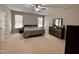 Serene bedroom featuring neutral colors, plush carpeting, a ceiling fan, and coordinated furniture for a calming retreat at 1005 Lathrop Ln, Apex, NC 27523