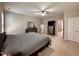 Spacious bedroom with soft carpeting, a ceiling fan, neutral paint, and modern dressers with coordinating mirrors at 1005 Lathrop Ln, Apex, NC 27523