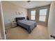 Comfortable primary bedroom with windows providing natural light and neutral tones creating a cozy atmosphere at 1005 Lathrop Ln, Apex, NC 27523
