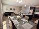 Open-concept dining and kitchen area with a large table, modern decor, and seamless flow to the living space at 1005 Lathrop Ln, Apex, NC 27523