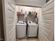 Efficient laundry room with a side-by-side washer and dryer, plus shelving for organization at 1005 Lathrop Ln, Apex, NC 27523