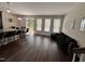 Open living area showcasing the kitchen island, dining area, and a glimpse of the outdoor patio through large windows at 1005 Lathrop Ln, Apex, NC 27523